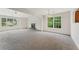 This bright living room features a fireplace, plush carpet, natural light and ceiling fans, perfect for relaxation at 5960 Castlegate Dr, Douglasville, GA 30135