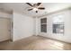 Spacious bedroom with a ceiling fan, neutral carpet, two windows that provide ample natural light at 400 17Th Nw St # 2308, Atlanta, GA 30363