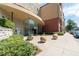Charming building entrance featuring decorative spheres, lush greenery, and pedestrian-friendly sidewalk at 400 17Th Nw St # 2308, Atlanta, GA 30363