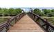 Wooden bridge over community pond with view of townhomes and green trees at 400 17Th Nw St # 2308, Atlanta, GA 30363