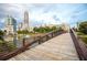 View of a wooden bridge over a community pond with townhomes in the distance at 400 17Th Nw St # 2308, Atlanta, GA 30363