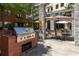 Outdoor brick grilling area with stainless steel grill and comfortable seating for entertaining at 400 17Th Nw St # 2308, Atlanta, GA 30363