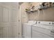 Convenient laundry room equipped with a white washer and dryer set, and shelving for storage at 400 17Th Nw St # 2308, Atlanta, GA 30363