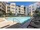 Beautiful pool with lounge chairs and umbrellas, perfect for relaxation with a backdrop of stylish building architecture at 400 17Th Nw St # 2308, Atlanta, GA 30363