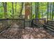 View of the back deck and wooded backyard with privacy fence of this traditional style home at 402 John Tate Nw Rd, Acworth, GA 30102