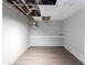 Basement with wood floors, gray walls and exposed ceiling utilities at 402 John Tate Nw Rd, Acworth, GA 30102