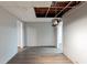 Finished basement with wood floors, gray walls and damaged ceiling at 402 John Tate Nw Rd, Acworth, GA 30102