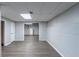 Open basement space with wood floors, gray walls, and some exposed ceiling and utilities at 402 John Tate Nw Rd, Acworth, GA 30102