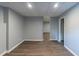 Finished basement with wood floors, gray walls and lots of open space at 402 John Tate Nw Rd, Acworth, GA 30102