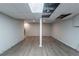 Large basement area with wood floors, gray walls and some exposed ceiling and stairs at 402 John Tate Nw Rd, Acworth, GA 30102