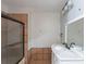 A bathroom featuring a shower with glass doors and a white double sink vanity at 402 John Tate Nw Rd, Acworth, GA 30102