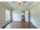 Spacious primary bedroom with hardwood floors, large window, and neutral paint waiting for renovations at 402 John Tate Nw Rd, Acworth, GA 30102
