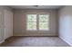 Bedroom with neutral paint, carpet, and a window offering natural light at 402 John Tate Nw Rd, Acworth, GA 30102