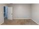 Vacant bedroom with neutral walls, beige carpet, and an open door to the upstairs hallway at 402 John Tate Nw Rd, Acworth, GA 30102