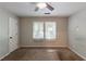 A vacant bedroom with two windows, a ceiling fan and beige carpet, ready for personalization at 402 John Tate Nw Rd, Acworth, GA 30102