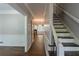 Open foyer with staircase and hardwood floors, flooded with natural light leading to the eat in kitchen at 402 John Tate Nw Rd, Acworth, GA 30102