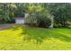 Traditional home featuring an attached two car garage, an ample front yard and mature landscaping at 402 John Tate Nw Rd, Acworth, GA 30102