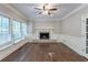 Living room with hardwood floors, fireplace, white trim, and bright windows for great light at 402 John Tate Nw Rd, Acworth, GA 30102