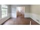 Spacious living room with hardwood floors, a staircase, and bright window light at 402 John Tate Nw Rd, Acworth, GA 30102