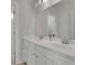 Bright bathroom with double vanity, white cabinetry and a large mirror at 545 Hanlon Way, Alpharetta, GA 30009