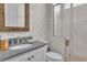 Modern bathroom featuring a glass enclosed shower, a decorative mirror, and elegant fixtures at 545 Hanlon Way, Alpharetta, GA 30009