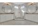 Luxurious bathroom showcases tiled shower, double sinks, large mirrors and modern lighting at 545 Hanlon Way, Alpharetta, GA 30009