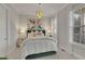Serene bedroom with a modern chandelier, accent art, and luxurious furnishings at 545 Hanlon Way, Alpharetta, GA 30009