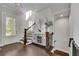 Inviting entryway with hardwood floors, staircase, natural lighting and decorative console table at 545 Hanlon Way, Alpharetta, GA 30009