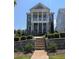 Stunning two-story home with brick facade, stately columns, second story balcony and manicured landscaping at 545 Hanlon Way, Alpharetta, GA 30009