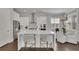 Modern kitchen featuring white cabinets, stainless steel appliances, an island and a breakfast nook at 545 Hanlon Way, Alpharetta, GA 30009