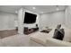 Spacious living room features recessed lighting, plush carpeting and a large screen tv at 545 Hanlon Way, Alpharetta, GA 30009