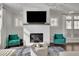 Cozy living room featuring a fireplace, modern furnishings and large windows at 545 Hanlon Way, Alpharetta, GA 30009