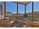 Screened-in patio featuring comfortable wicker seating and views of the neighborhood at 545 Hanlon Way, Alpharetta, GA 30009