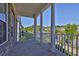 Covered porch area boasts white columns and views of the neighborhood at 545 Hanlon Way, Alpharetta, GA 30009