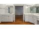 Spacious bathroom features double vanity with white countertops and hardwood floors at , Dunwoody, GA 30338