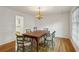 Dining room with hardwood floors, a chandelier, and classic chair rail details at , Dunwoody, GA 30338