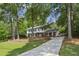 Traditional two-story home with brick accents, black shutters, and a long driveway surrounded by mature trees at , Dunwoody, GA 30338