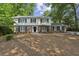 Charming two-story home with brick and siding exterior, black shutters, and well-manicured landscaping at , Dunwoody, GA 30338