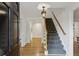 Bright foyer with hardwood floors, staircase, and an elegant light fixture, creating a welcoming entrance at , Dunwoody, GA 30338