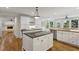 Bright kitchen boasts white cabinets, hardwood floors, and a center island with granite countertop at , Dunwoody, GA 30338