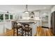 Open kitchen with stainless steel appliances, hardwood floors, and island with bar seating at , Dunwoody, GA 30338