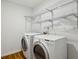 Functional laundry room with washer, dryer, and wire shelving, designed for efficiency at , Dunwoody, GA 30338