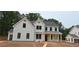 Stunning new construction featuring a modern farmhouse style with white siding, black trim and inviting front porch at 4615 Greyson Manor Dr, Cumming, GA 30041