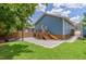 Charming backyard features a stone patio, a wooden deck with slide, string lights, and a cozy built-in bench at 496 Rankin Ne St, Atlanta, GA 30308
