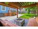 Inviting backyard with a fire pit, wooden benches, lush lawn, and pergola at 496 Rankin Ne St, Atlanta, GA 30308