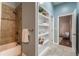 Bathroom features tiled shower, built-in shelving, and ensuite access to bedroom at 496 Rankin Ne St, Atlanta, GA 30308