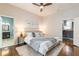 Cozy bedroom featuring hardwood floors, ceiling fan, and ensuite access to bathroom and kitchen at 496 Rankin Ne St, Atlanta, GA 30308