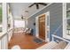 Welcoming porch with furniture, swing, dark wood floor, ceiling fan and view of the wood front door at 496 Rankin Ne St, Atlanta, GA 30308