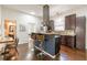 Modern kitchen with bar-stool seating, stainless hood, and wood floors at 496 Rankin Ne St, Atlanta, GA 30308