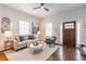 Inviting living room featuring a comfortable sofa, stylish decor, and a view of the wood front door at 496 Rankin Ne St, Atlanta, GA 30308
